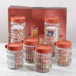 Precio de fábrica, juego de cuatro piezas, frascos sellados de vidrio transparente, dulces, galletas, botellas de almacenamiento de grado alimenticio con tapa