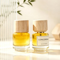 Nouvelle conception de flacon de parfum miniature rond en verre transparent de 30 ml, flacon de parfum vide avec bouchon en bois et boîte d'emballage