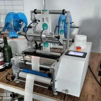 Vente à chaud imprimante de code de date manuelle semi-automatique machine d'étiquetage de bouteilles rondes d'eau en verre plastique PET autocollant