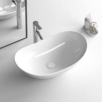 Vasque de salle de bain ovale moderne en céramique, design élégant, à poser sur comptoir, pour aménagement sanitaire public