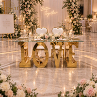Table de mariage moderne de luxe en acier inoxydable doré brillant avec inscription LOVE, idéale pour événements et réceptions