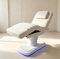 Lit de beauté électrique multifonctionnel en cuir côtelé blanc avec moteur, appui-tête amovible, base LED pour salon, spa, soins du visage