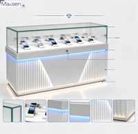 Table de présentation de téléphone portable Maxsen, en verre, avec éclairage LED ambiant, affichage numérique gris et blanc, robuste et écologique, pour usage commercial