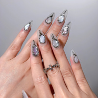 Faux ongles en acrylique faits main, base blanc crème, bordure métallique effet lave, incrustation nacre irisée, forme amande, longueur moyenne, personnalisables
