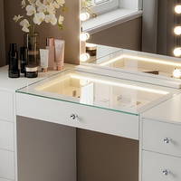 Coiffeuse moderne en panneau de particules avec miroir lumineux à intensité réglable et plusieurs tiroirs pour chambre à coucher OEM ODM