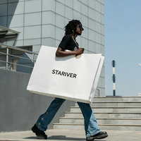 Sac de transport en papier blanc surdimensionné à impression personnalisée, poignées en ruban noir, œillets métalliques, emballage pour magasin de vêtements