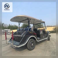 Voiturette de golf électrique noire et champagne au style vintage pour le transport dans les complexes hôteliers et l'hôtellerie