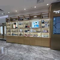 Lunettes de soleil murales rondes personnalisées avec éclairage LED moderne Étagère d'affichage de lunettes en verre pour magasin de lunettes de vue
