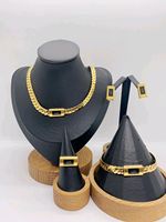 Parure de bijoux quatre pièces en acier inoxydable avec pendentifs lettre S et signe dollar, style Moyen-Orient