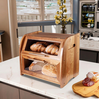 La boîte de rangement à pain à deux couches en bois d'acacia avec des couvercles de fenêtre en verre pour le stockage des aliments dans la cuisine.