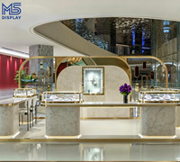 Comptoir de présentation de bijoux de luxe sur mesure avec cadre en arche doré, éclairage LED et base en marbre pour magasin de bijoux et boutique de détail