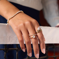Cincin jari bergelombang bertumpuk dengan permukaan cermin poles premium, warna emas 18K, bertabur rhinestones berkilauan, untuk tampilan pesta koktail.