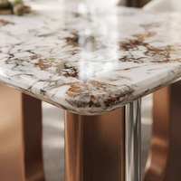 Table de salle à manger contemporaine haut de gamme en pierre frittée écologique avec piétement métallique bicolore pour villa de luxe