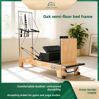 Reformador de Pilates de doble uso de roble con media torre y tabla de salto para sesiones de entrenamiento en pareja y fitness en sala