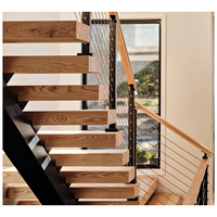 Escalier à monopoutre en acier découpé au laser, marches en noyer massif, système de balustrade en verre