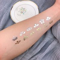 Autocollant de tatouage doré personnalisé à la mode, papier transfert à l'eau, film PET, feuille métallique, tatouage temporaire pour la décoration du corps, durable