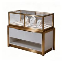 Vitrine de présentation de bijoux en verre LED de luxe moderne, en acier inoxydable robuste, couleurs personnalisables, finition polie
