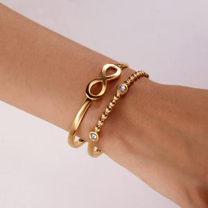 Brazalete recortado de vanguardia SZ118-Brazalete asimétrico de acero inoxidable con perforaciones geométricas para apilamiento de bordes urbanos - Product Image 1