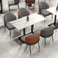 Chaise de salle à manger de luxe en pierre à motif pied-de-poule avec pieds en métal doré en forme d'arachide pour usage en restaurant