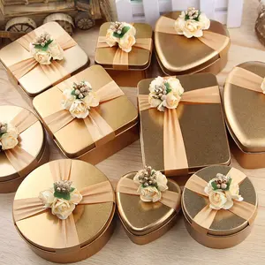 סיטונאי יוקרה אריזת זהב שוקולד ממתקי חתונה בצורת לב פח קופסת מתנה מתוקה עם סרט ופרח