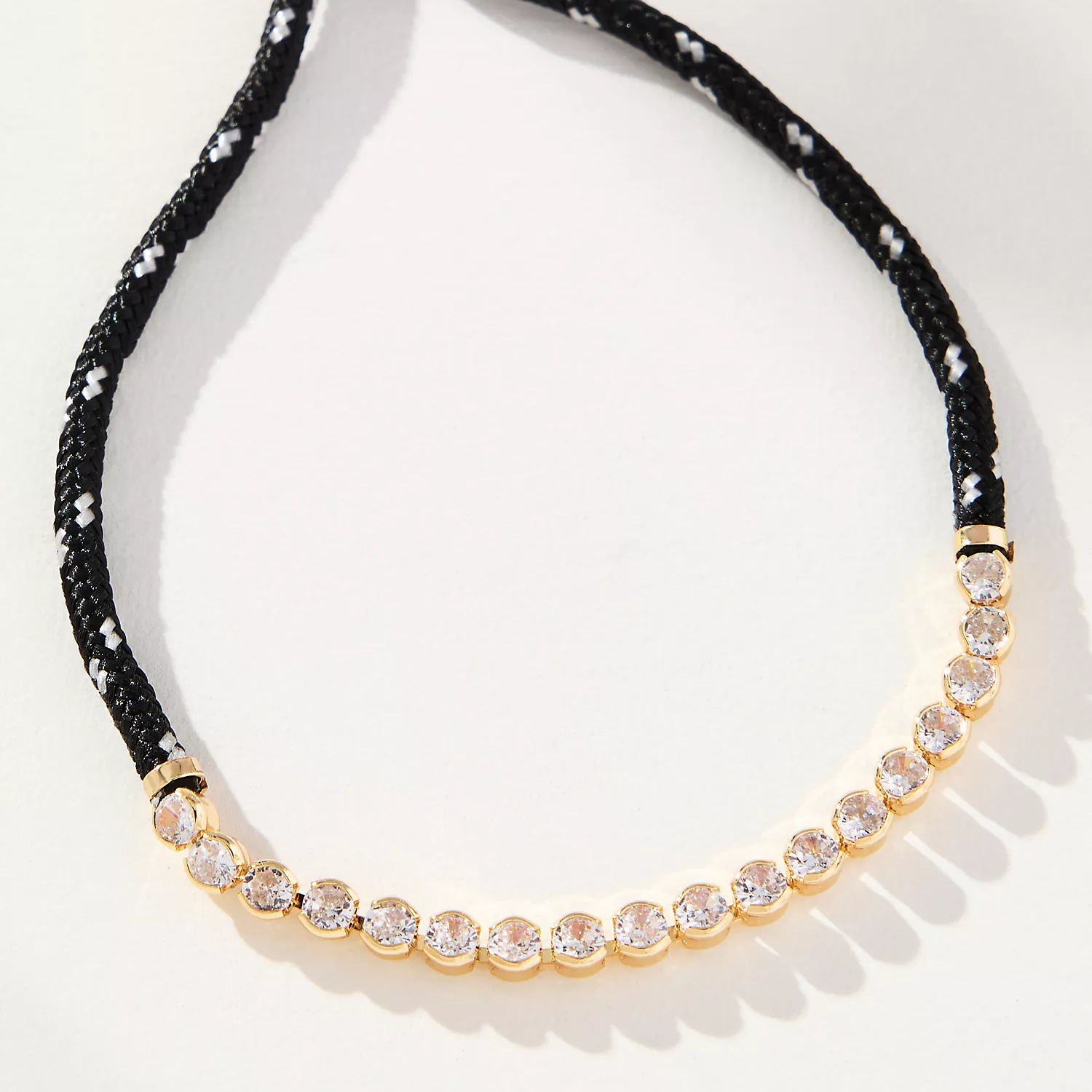 Pulsera de cuerda negra con estampado blanco.