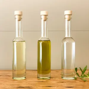 Botellas de vidrio para alimentos de aceite de oliva vinagre de lujo vacías de fondo grueso redondo Super Flint producidas en fábrica reciclables con tapa de corcho