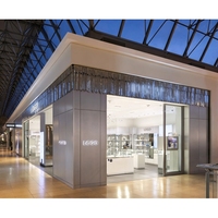 Bureau de réception incurvé sur mesure pour partenaires Fortune 500, avec éclairage de plafond circulaire, pour zone VIP de marque de montres de luxe