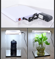 Étagère de présentation de bouteilles en acrylique portable fabriquée à la main en Chine avec base lumineuse LED, forme personnalisée