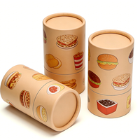 Emballage en tube cylindrique en carton écologique fait main à motif burger et frites, avec matériaux recyclés pour la restauration rapide et les collations