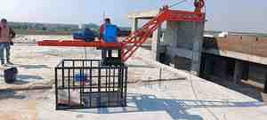 Industrial electric material lifting <b>winch</b> machine installed on rooftop construction site with motor gearbox and steel frame - Product Image 4