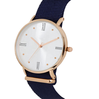 Montre DW unisexe minimaliste avec boîtier en alliage or rose, mouvement à quartz argenté, cadran bleu marine, bracelet en nylon et verre minéral