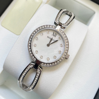 Montre pour femme de luxe simple à quartz, bracelet en strass en forme de fer à cheval creux, cadran en nacre blanche, lunette entièrement sertie de cristaux