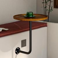 Table murale ronde moderne de petite taille avec plateau en bois massif et support en fer thermolaqué, idéale pour les cafés en plein air et les salons de thé.
