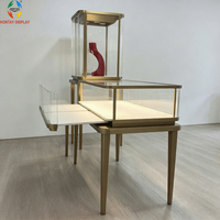 Vitrine de présentation de bijoux de luxe avec éclairage LED, cadre en acier inoxydable brossé doré, verre trempé, comptoir pour boutique et salle d'exposition