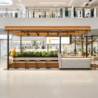 Kiosque de vente en bois chaud et pierre patinée avec éclairage LED, design écologique, proposant des glaces à la pistache