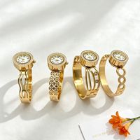 Montre bracelet pour femme à cadran rond incrusté de diamants, motifs ajourés multiples, bracelet en acier titane doré brillant