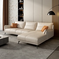 Canapé d'angle moderne en cuir véritable crème avec coussins confortables pour un salon luxueux