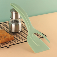 Pince alimentaire 2-en-1 en nylon et silicone pour le retournement des œufs et la pelle pour les ustensiles de cuisine.