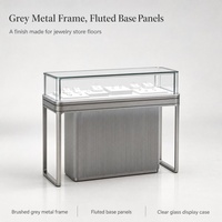 Vitrine de présentation de bijoux en verre avec cadre métallique gris et base cannelée, type îlot, pour magasin de détail, boutique, salle d'exposition, kiosque de centre commercial