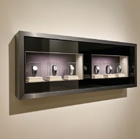 Vitrine murale de luxe en métal noir brossé avec éclairage LED pour montres et bijoux de luxe, personnalisable