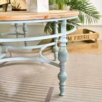 Table basse INNOVA vintage rustique ronde en bois massif avec plateau sculpté et pieds en métal pour salon
