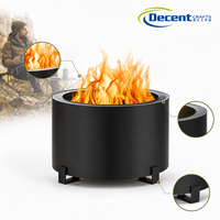 Perapian kayu bakar portabel bundar warna hitam matte untuk luar ruangan dengan tiga kaki logam berbentuk L, desain minimalis untuk teras.
