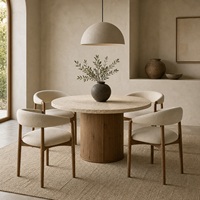 Ensemble de salle à manger rond en travertin Wabi-Sabi avec base en chêne et fauteuils crème pour villas de luxe et projets hôteliers