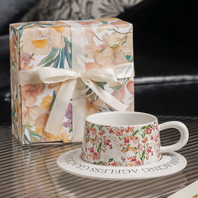 White cups and saucers - lily-shaped box with ribbon