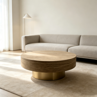 Table basse moderne en bois avec piétement doré champagne, plateau texturé aspect pierre, table centrale circulaire pour salon