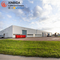 Bâtiment de stockage commercial en acier de grande capacité avec structure en poutres en H Q355B soudées, certifié CE, système de panneaux isolants en PU