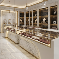 Ensemble de vitrines de luxe pour bijoux, comptoirs de vente en verre, motif marbre blanc, finition dorée, éclairage LED pour projets de bijouteries