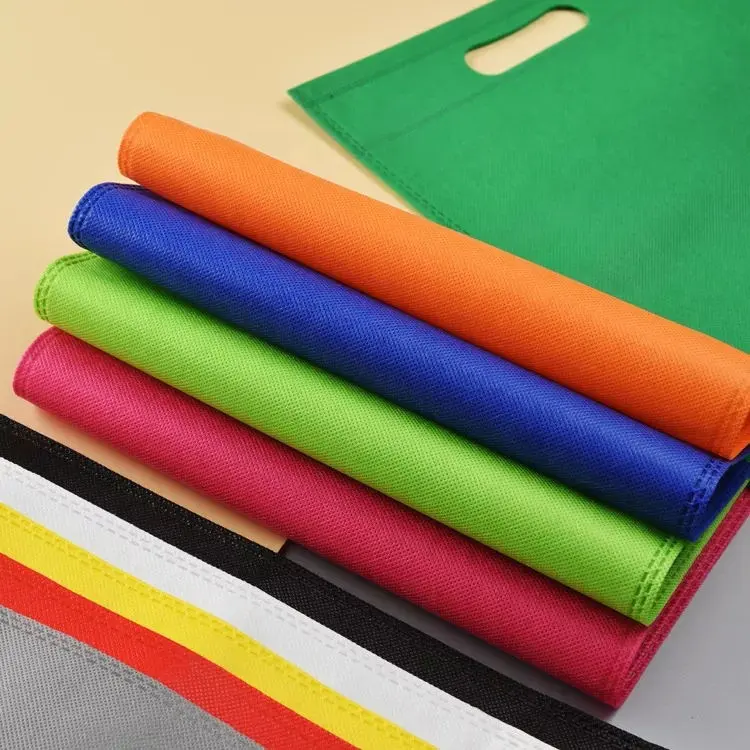 गैर-बुने हुए कपड़े का कैरी शॉपिंग बैग थोक पेशेवर कस्टम पर्यावरण-अनुकूल रंगीन गैर-बुना डी-कट बैग