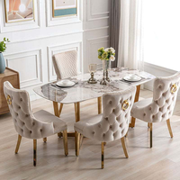 Chaise de salle à manger moderne capitonnée haut de gamme avec anneau de traction tête de lion, revêtement en velours gris, structure en acier inoxydable