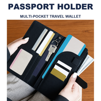 Porte-passeport multi-poches en cuir PU Saffiano, portefeuille de voyage avec 7 emplacements pour cartes, boucle pour stylo, fenêtre pour carte d'identité, porte-clés, poche zippée pour billets de banque